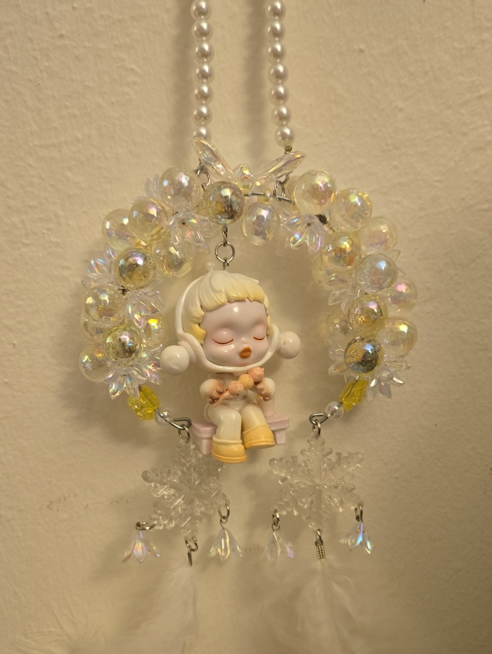 This handmade car ornament features a Pearl Beaded hanger and a Skull Panda